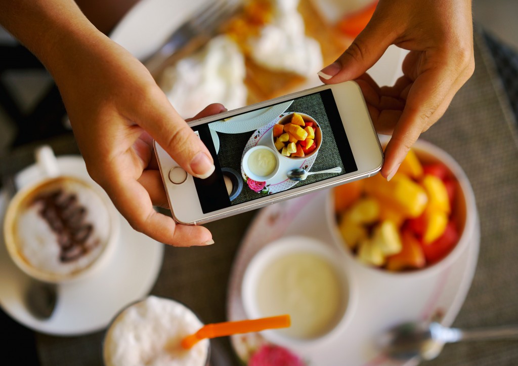 person taking a picture of food