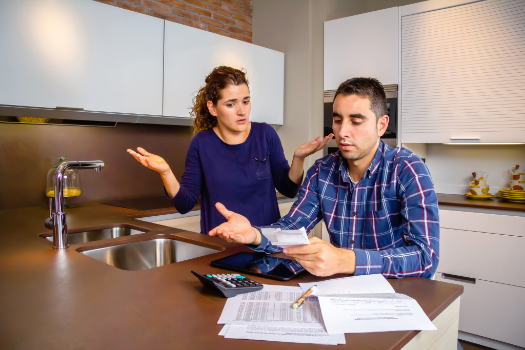 couples stressing out while looking at bills