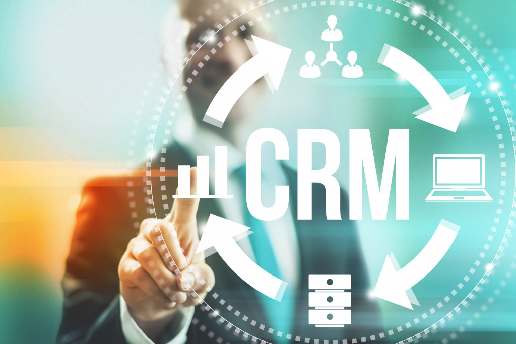 a businessman selecting CRM; CRM concept graphics