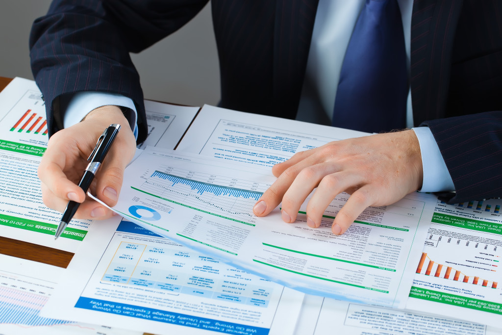 a man holding documents to forecast data