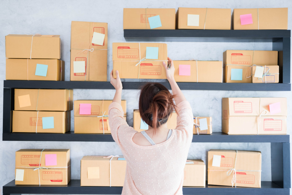 a person arranging the boxes