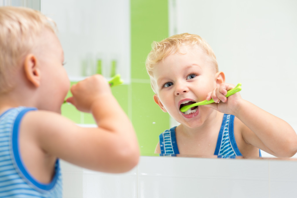 male kid brushing teeth 