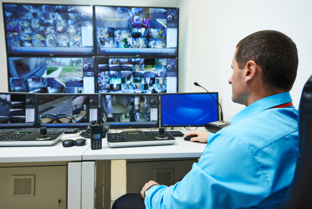 security guard watching video surveillance system