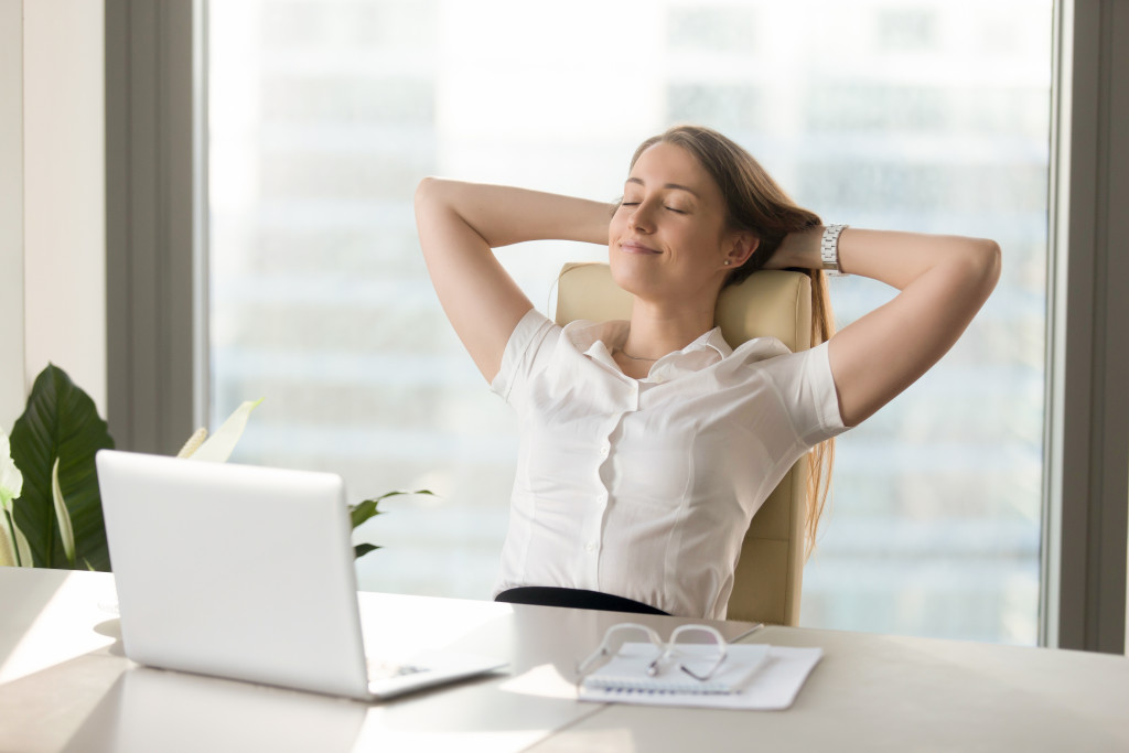 A Woman Sitting Comfortably at a desk at home