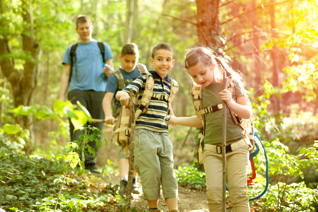 kids forest with their dad at the back