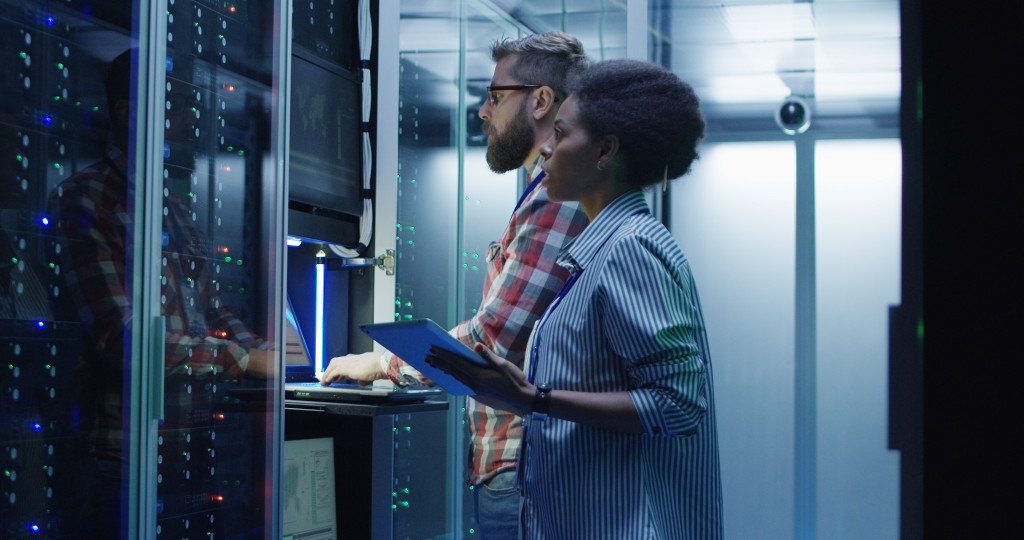 2 person in a server room