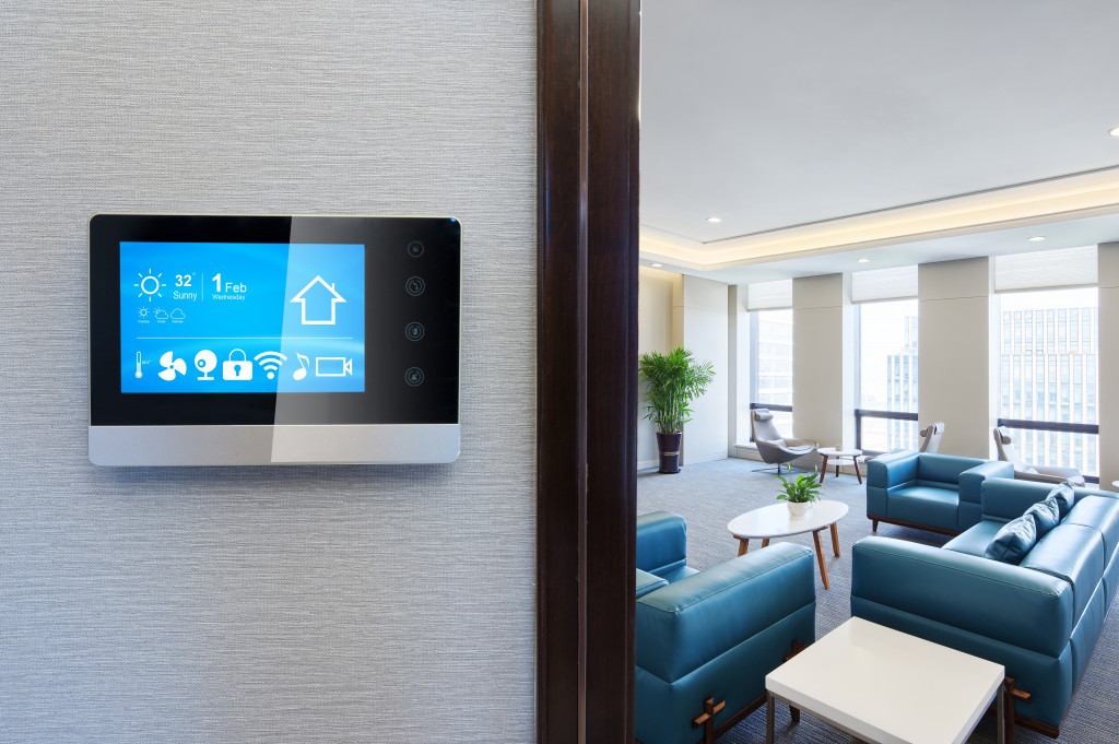 Smart home device on a wall with blue furniture in the background