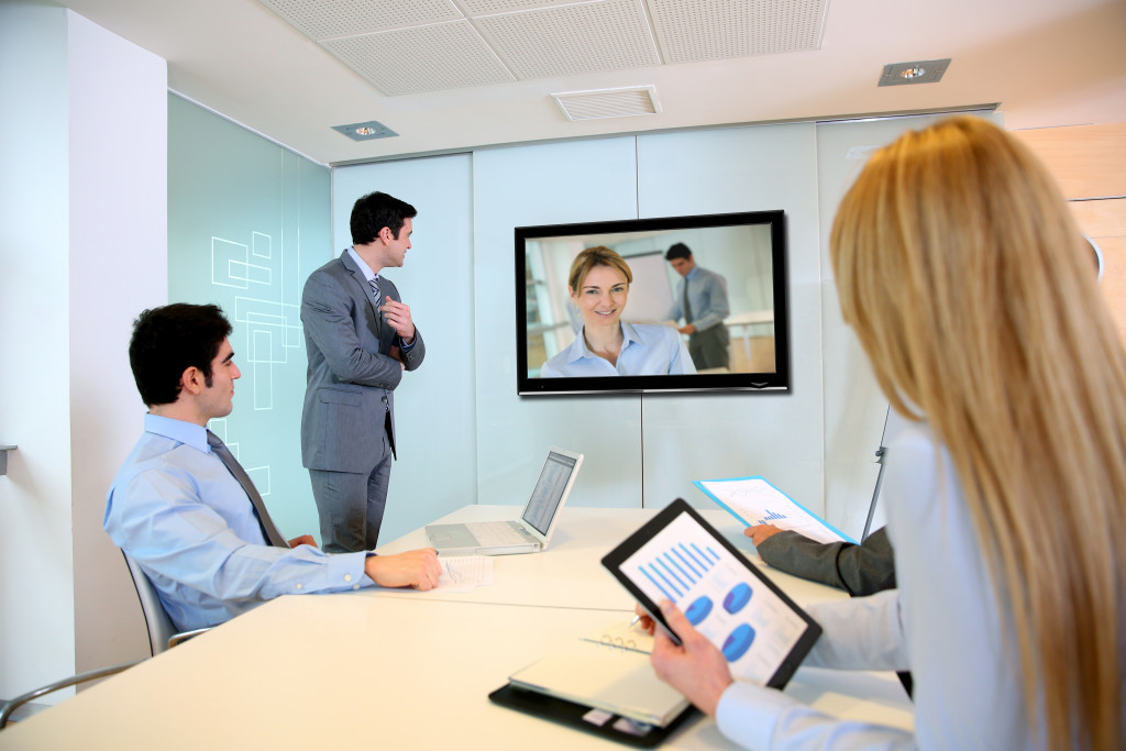 employees conducting a meeting using videoconferencing tools