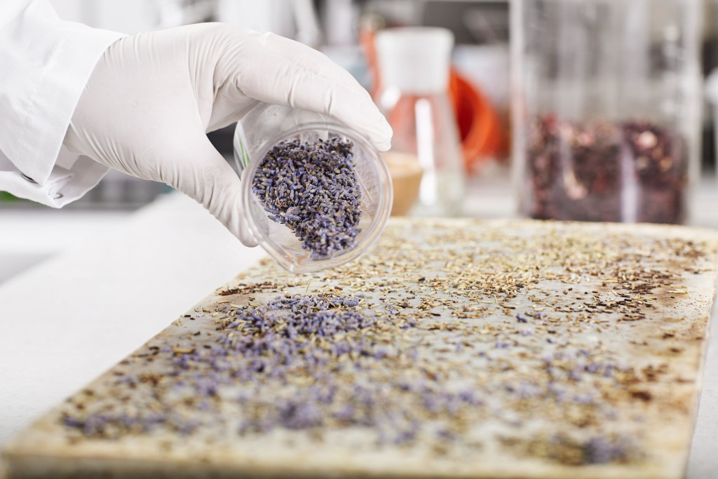 a close up of a scientist using natural ingredients in cosmetic formulation