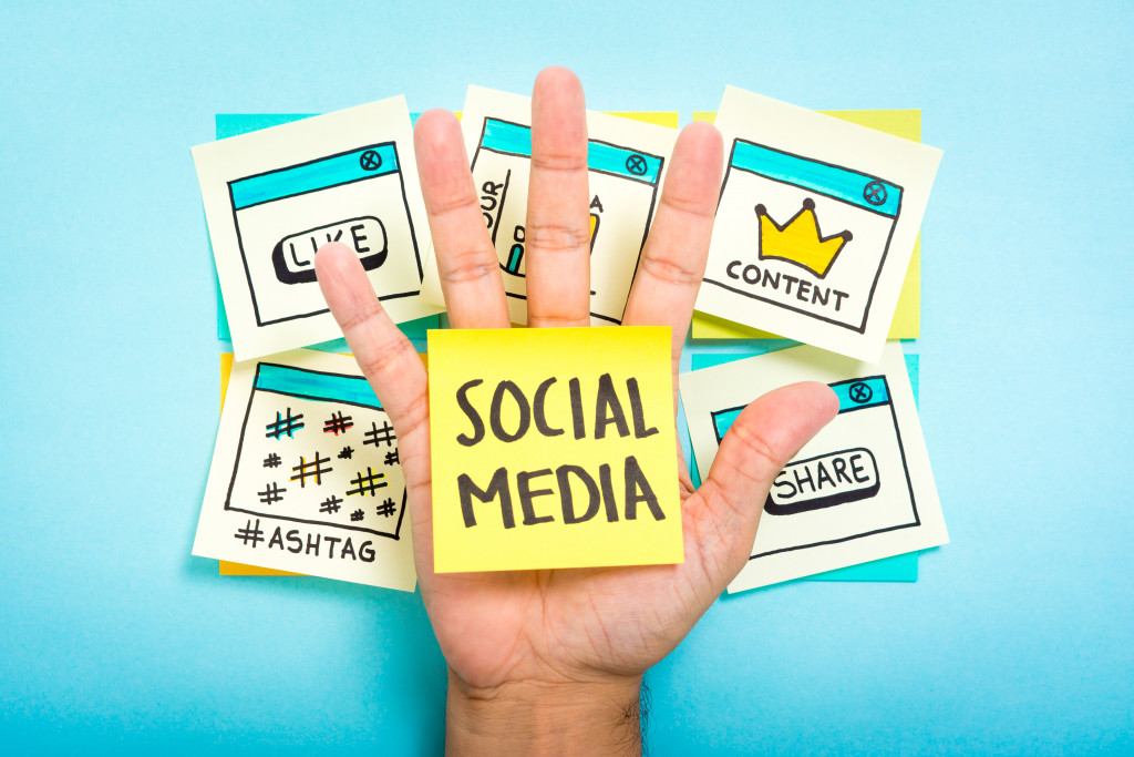 hand with social media sign and logos