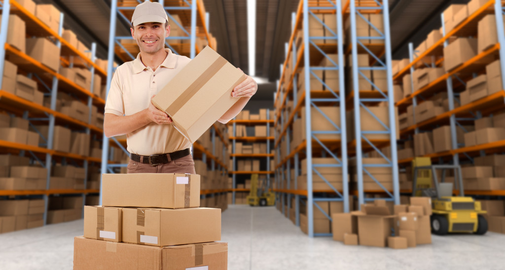 A man holding a box in a warehouse