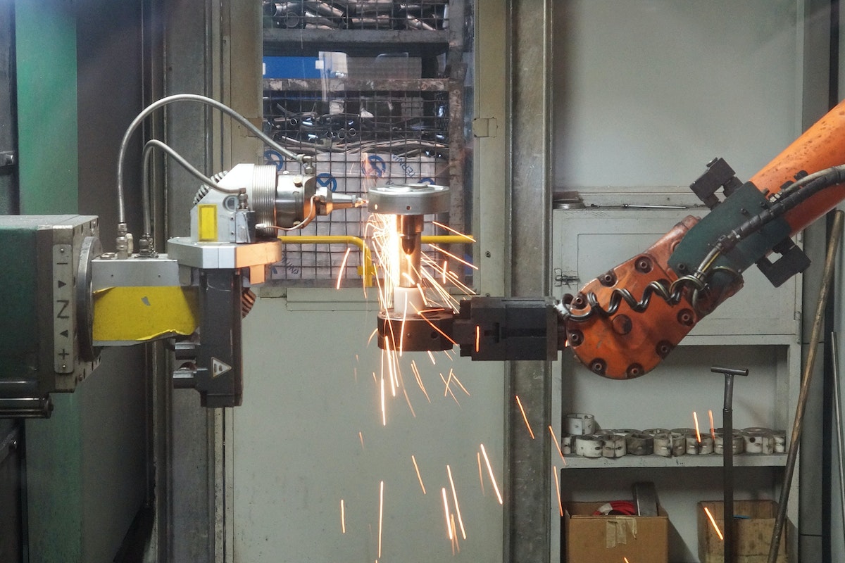 A Robot Industrial Machine Grinding a Steel