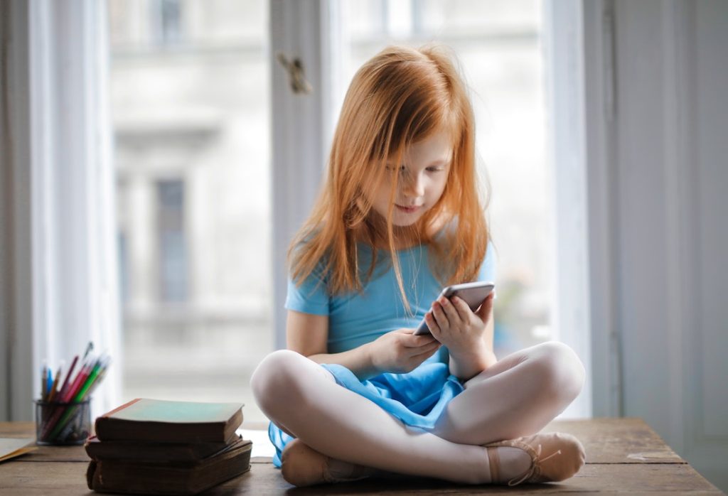 child playing with her phone