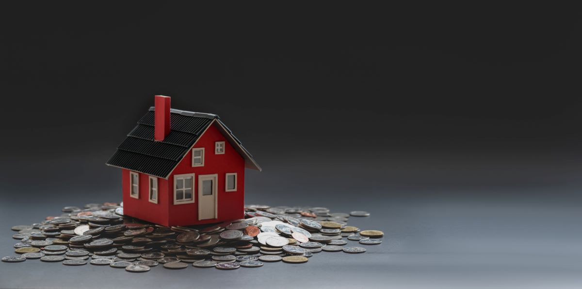 tiny red house with coins under