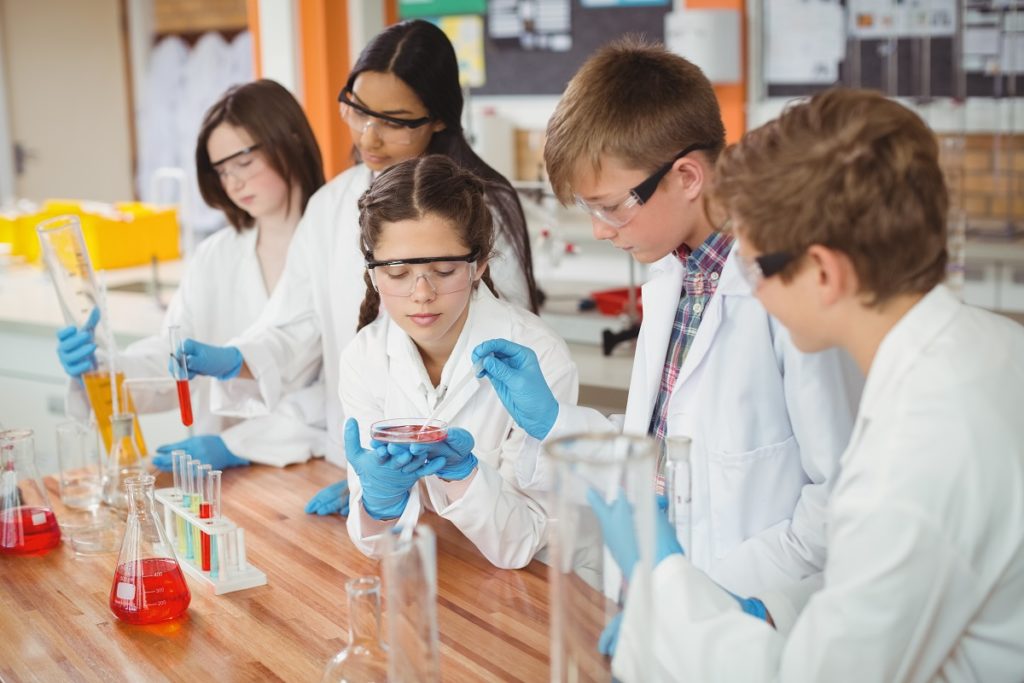 students wearing protective glasses in the laboratory